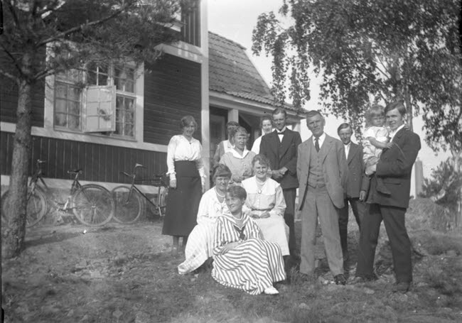 Arvid Källström med flera poserar framför ett hus.