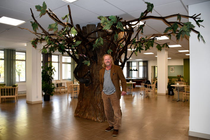 Konstnären Gösta Holmér framför sitt konstverk Urträdet.